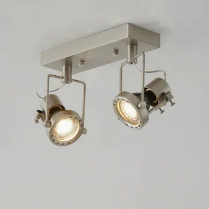 Close-up front view of 2-head ceiling spotlight with one illuminated lamp and brushed nickel finish