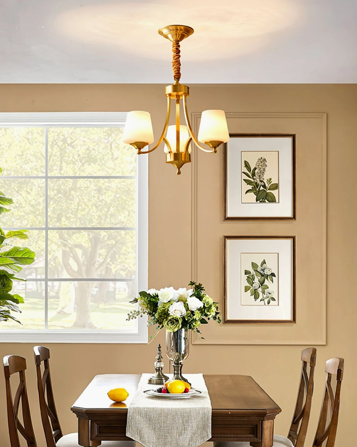 4-light mid-century brass chandelier in casual dining room with floral centerpiece and botanical decor