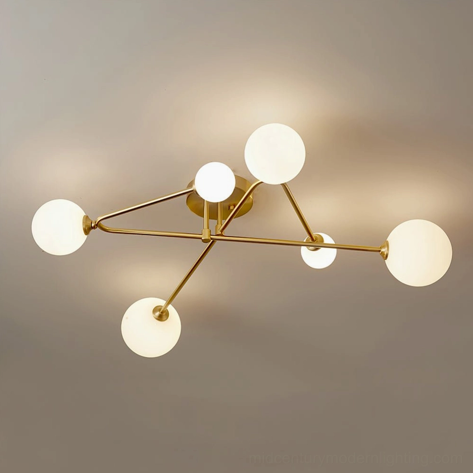 6-light sputnik ceiling lamp installed on ceiling showing polished brass arms and matte frosted globes