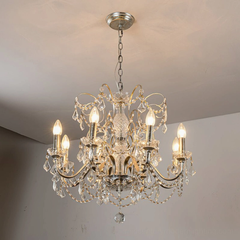 Illuminated 8-head Fauna chandelier with silver finish and crystal elements creating ambient warm light in residential space