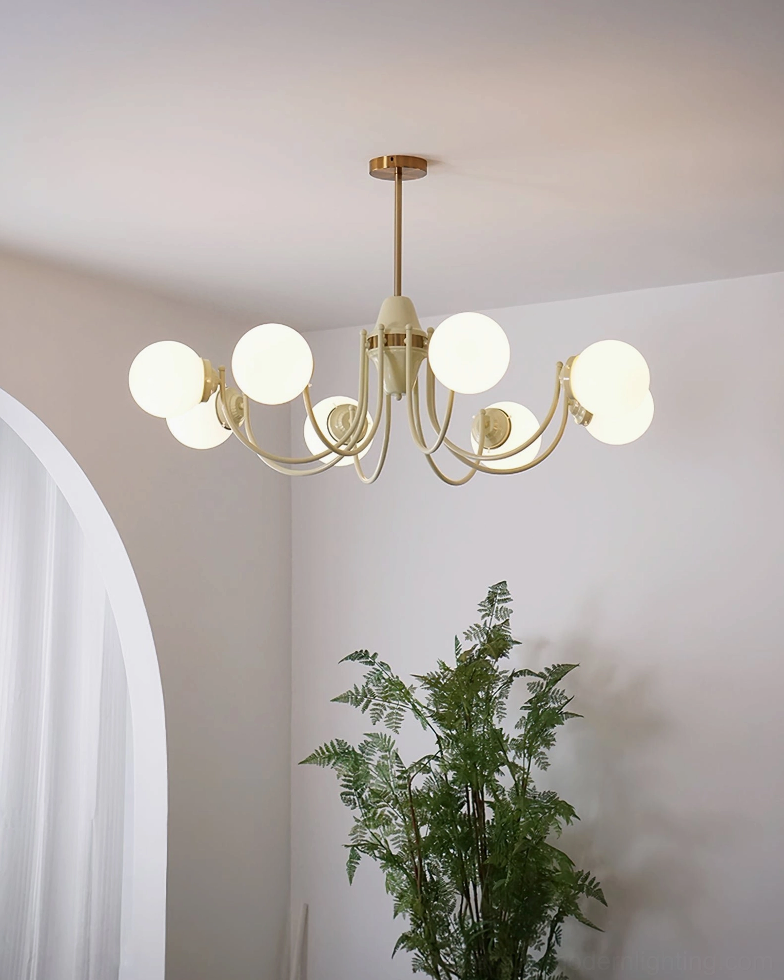 Eight-head globe chandelier with illuminated spherical cream and gold shades in minimalist room