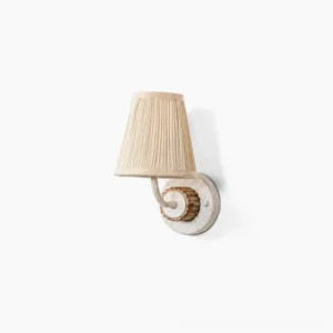 Abbey pleated fabric wall sconce three-quarter view showing curved metal arm and beige shade