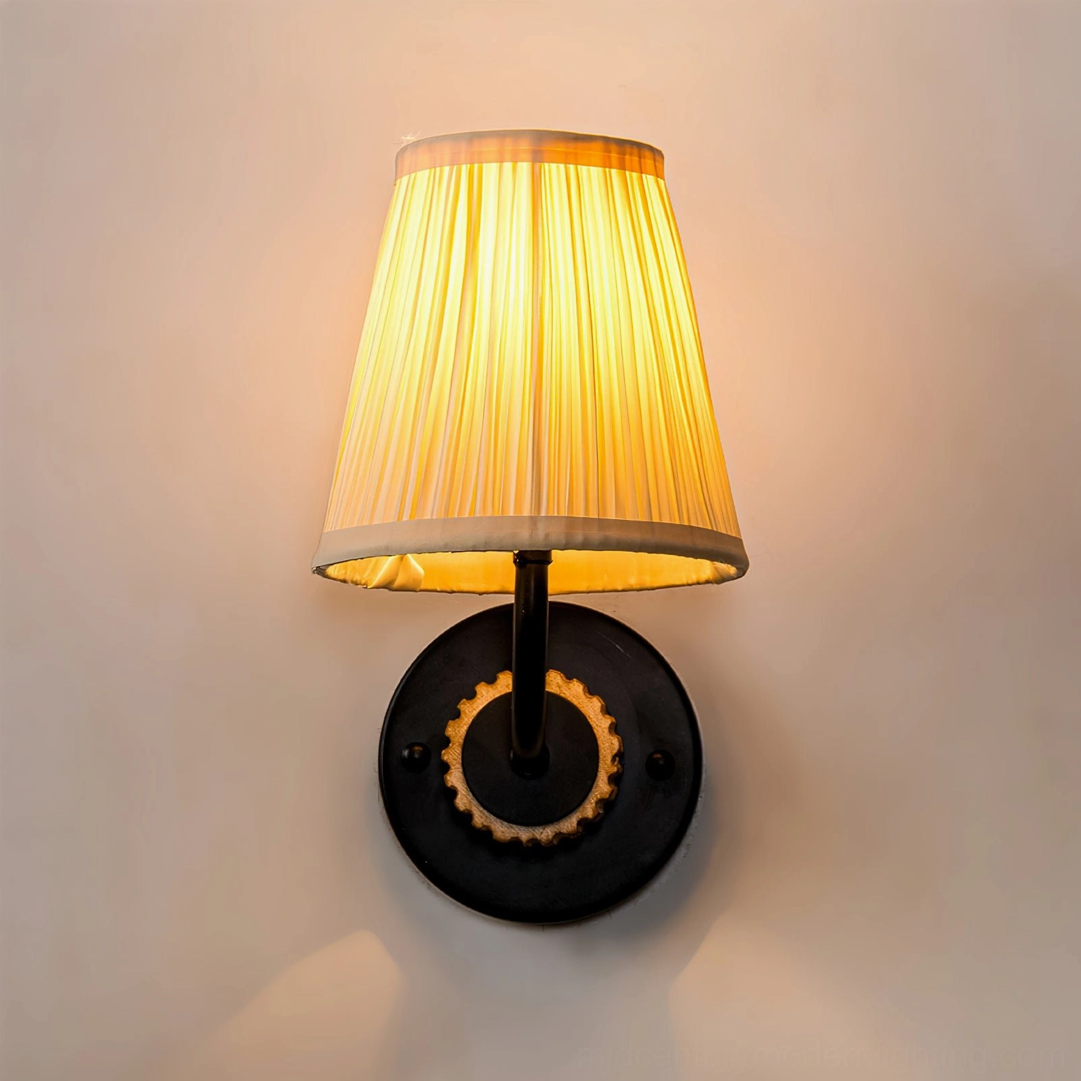 Illuminated Abbey sconce lit from below highlighting warm light quality and shade texture