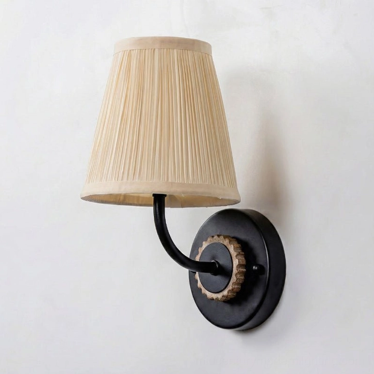 Abbey wall light with black metal arm and matte black base plate on white background