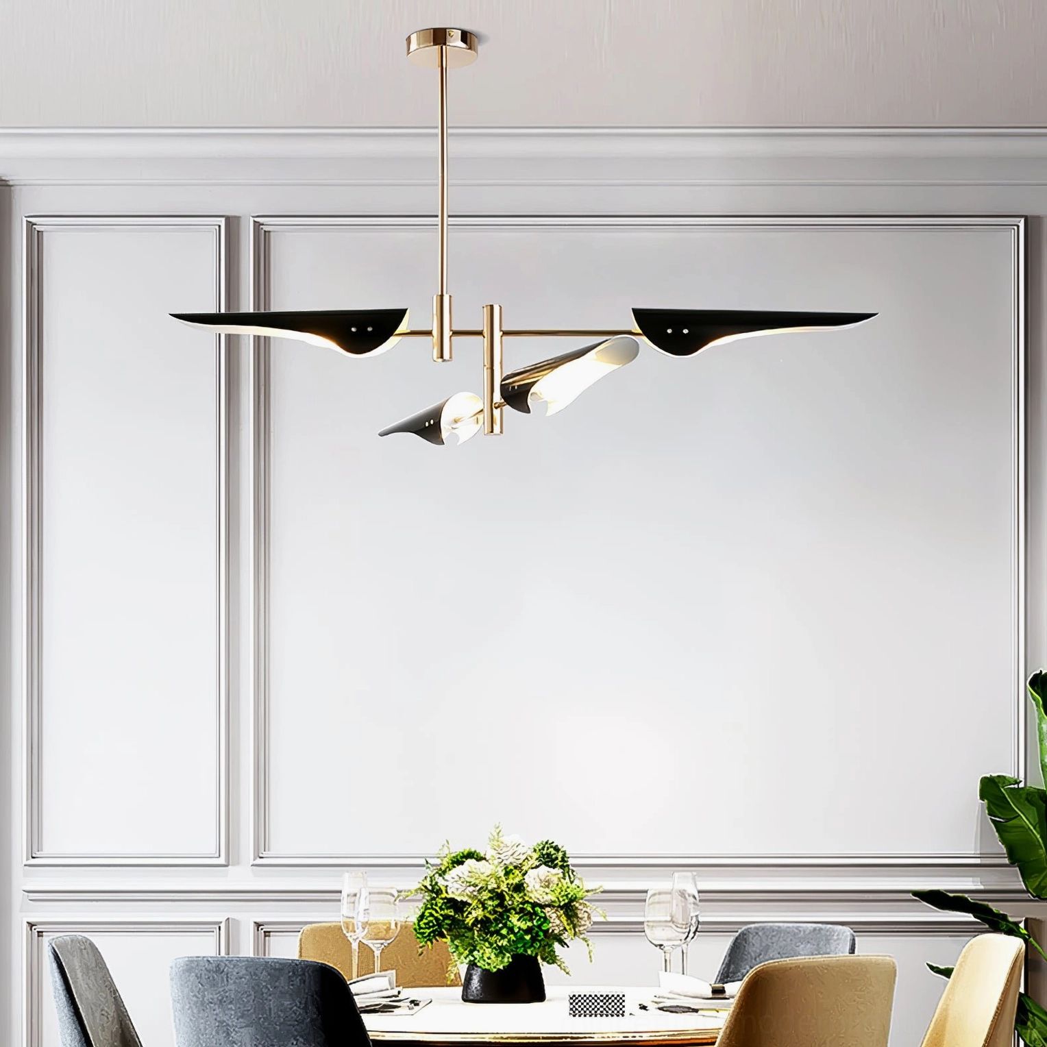 Compact modern dining chandelier with brass frame and angled black lamp heads in formal paneled dining room