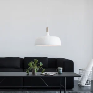 White Acorn pendant lamp illuminated in modern minimalist living room with black sofa