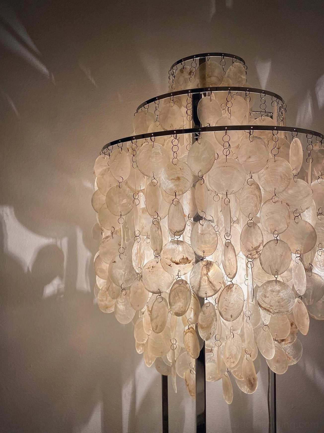 Mother of pearl shell floor lamp creating warm acoustic ambient experience