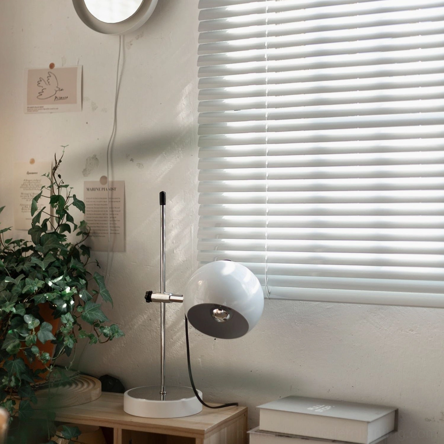 Two-tone adjustable ball bracket lamp with silver metal pole and black shade on home desk