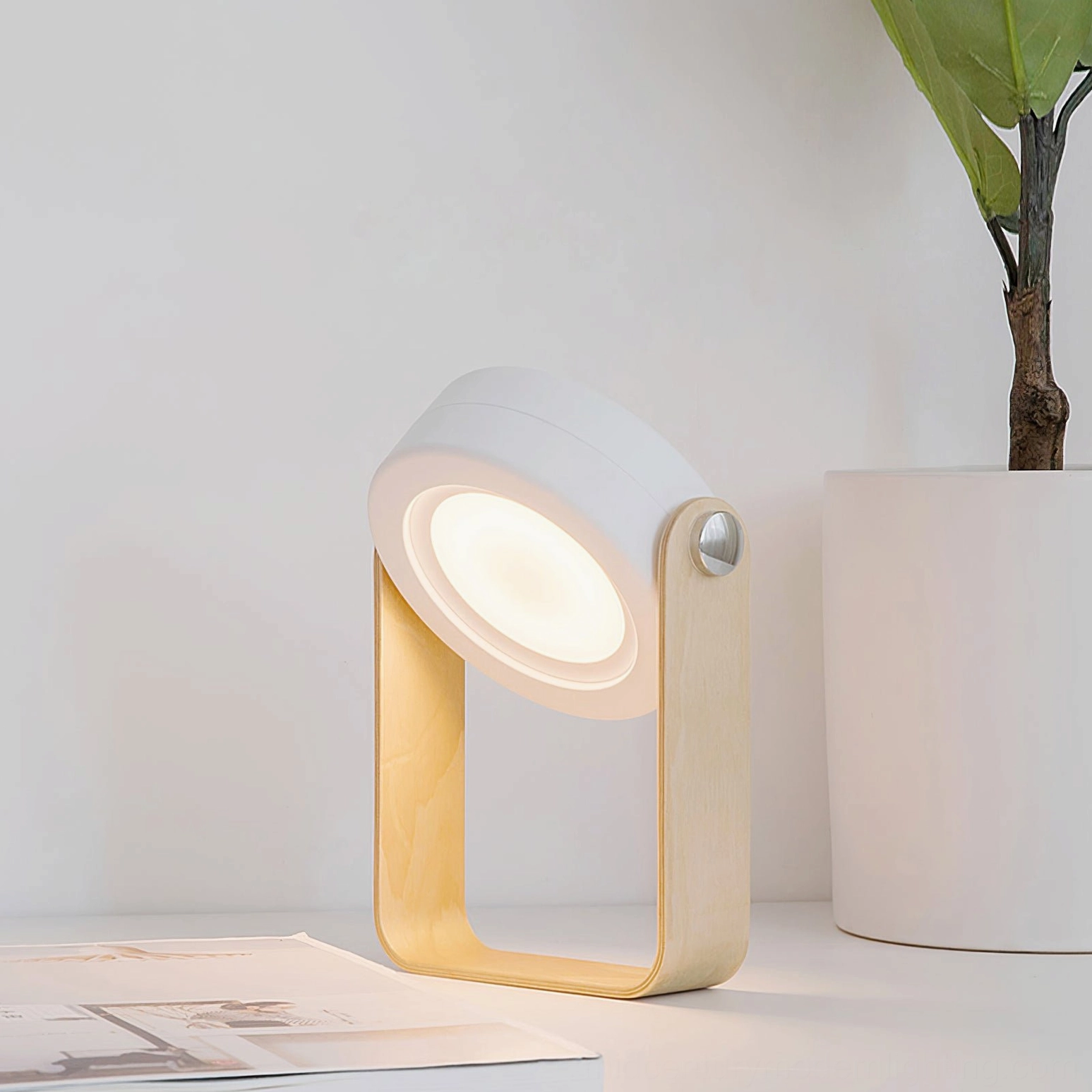 Adjustable dimmable lantern table lamp on minimalist nordic desk, side angle view showing honeycomb light filtering structure
