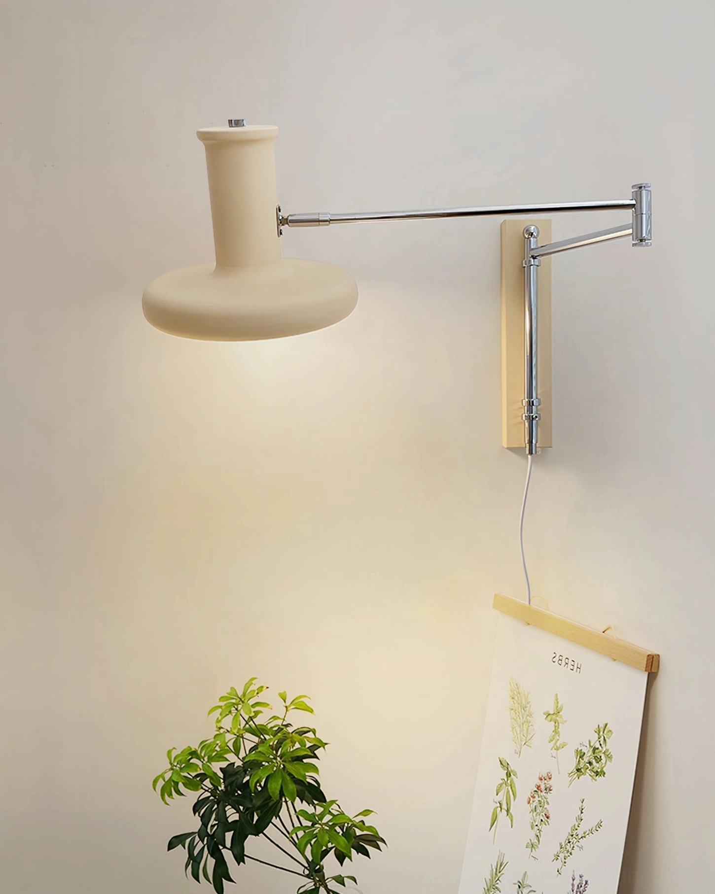 Mid-century modern swing arm wall light mounted in contemporary interior showing adjustable articulation and cream finish styling