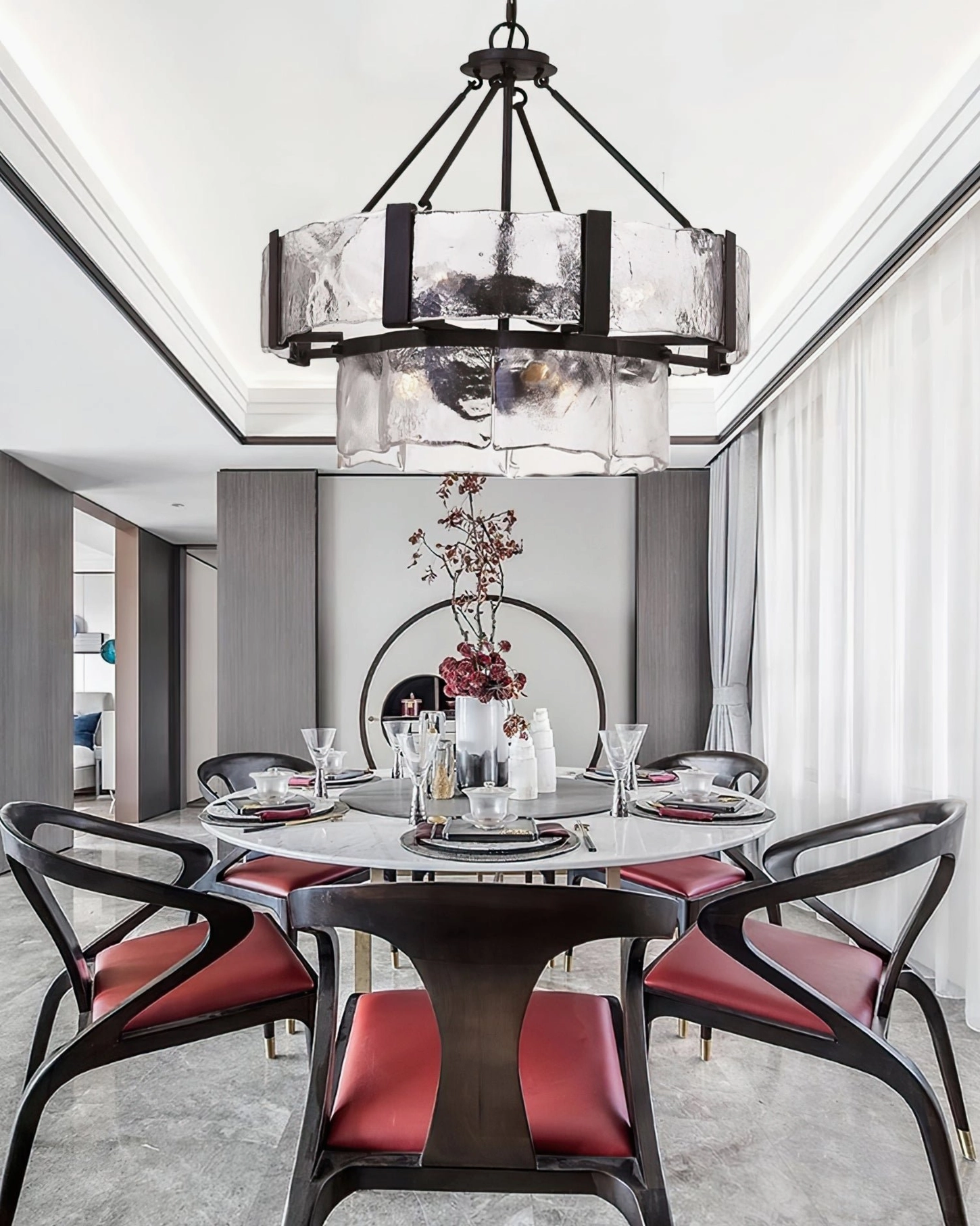 Double-tier rippled glass pendant in formal dining room with dark wood and red upholstered seating