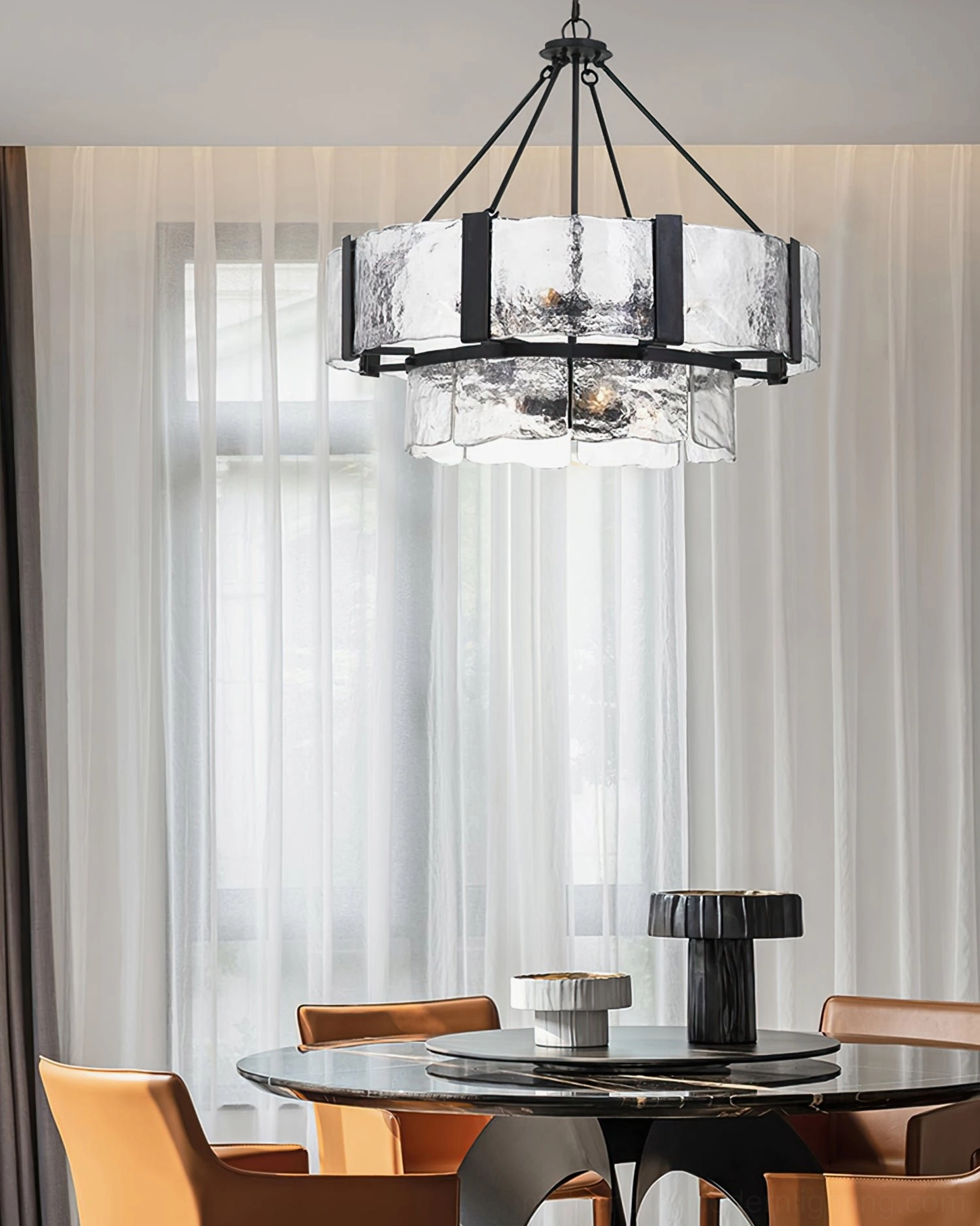Mid-century modern glass chandelier in contemporary dining room with orange leather dining chairs