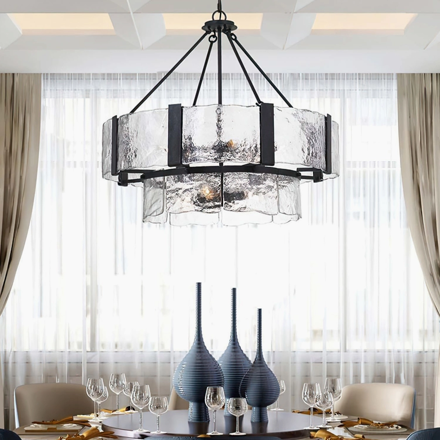 Aenon glass pendant chandelier installed in modern luxury dining room creating ambient lighting above table