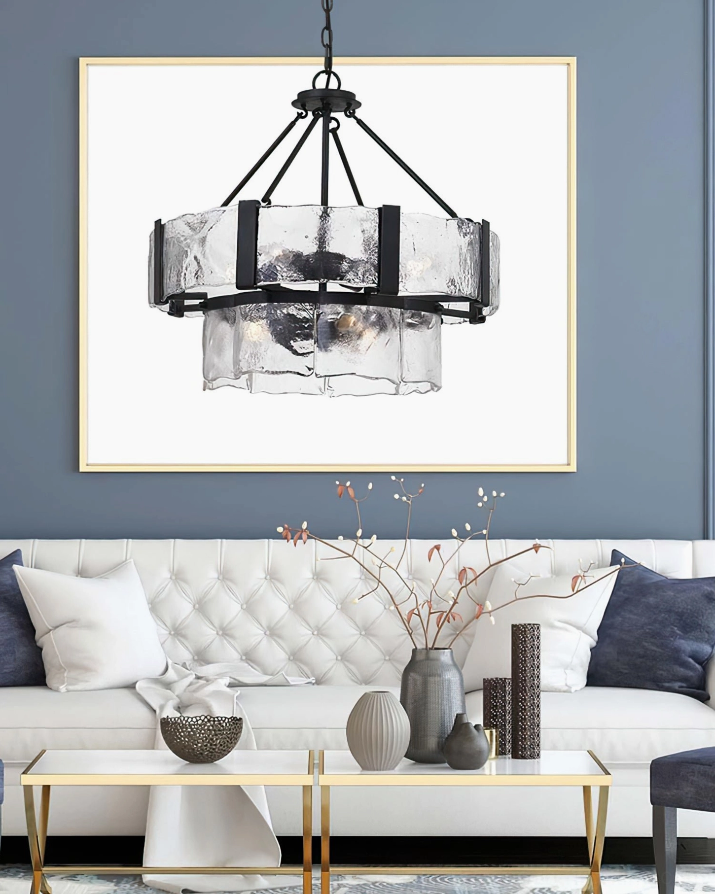 Two-tier glass chandelier in contemporary living room with tufted sofa and neutral modern furnishings
