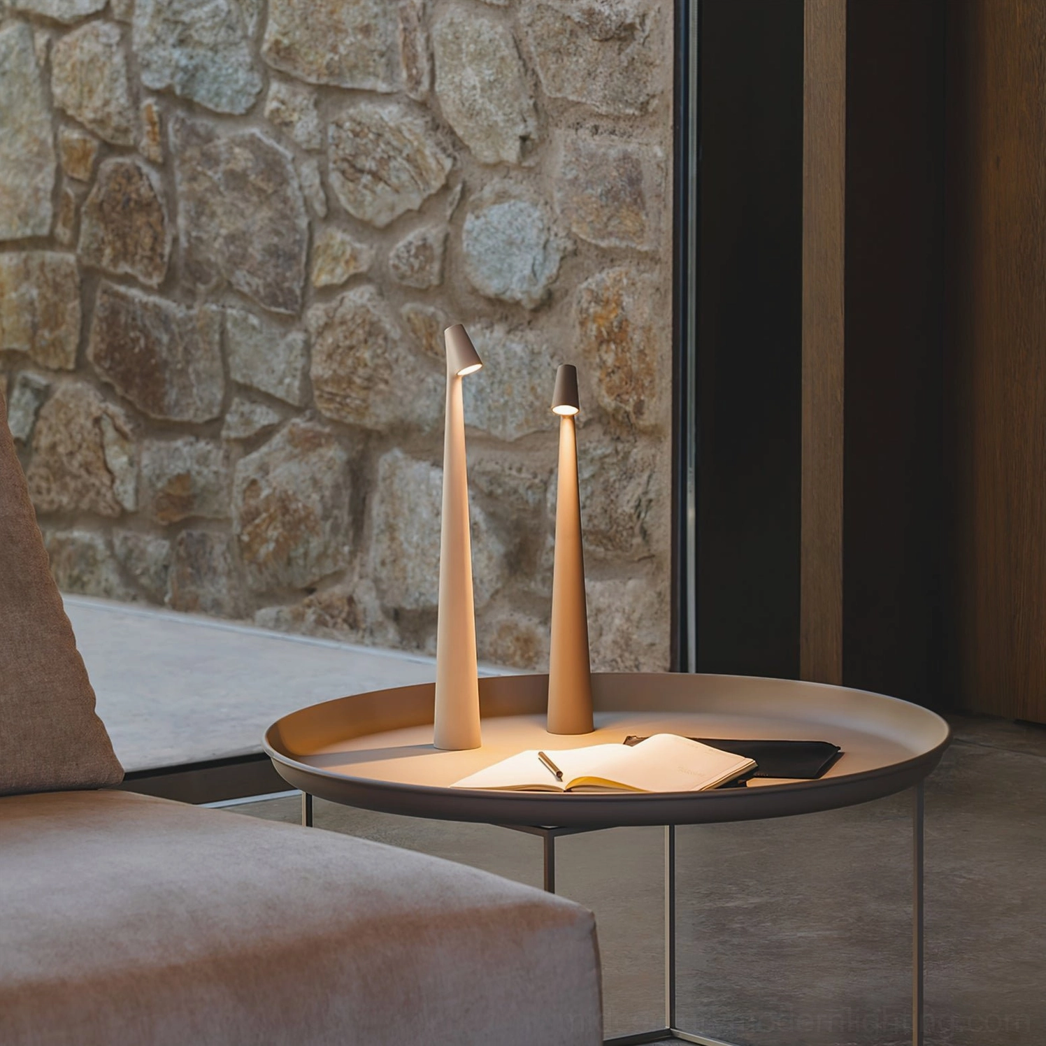 Pair of Africa cordless table lamps in modern living room with stone wall backdrop