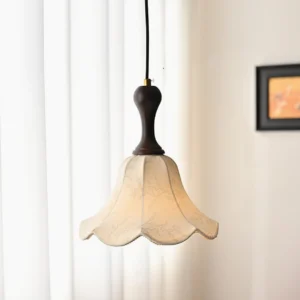 Agnes pendant light hanging indoors with warm glow, side angle view near window curtain