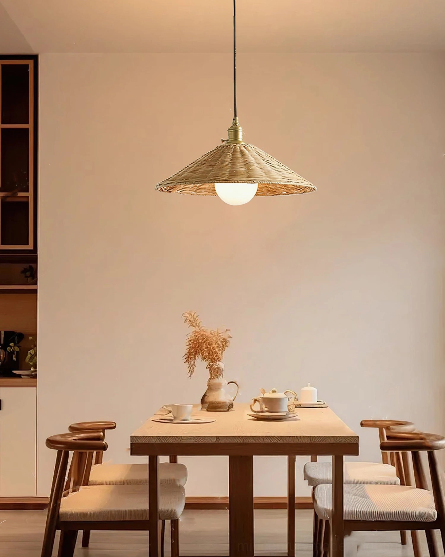Agoura rattan pendant light in minimalist dining space with clean wooden furniture and neutral interior