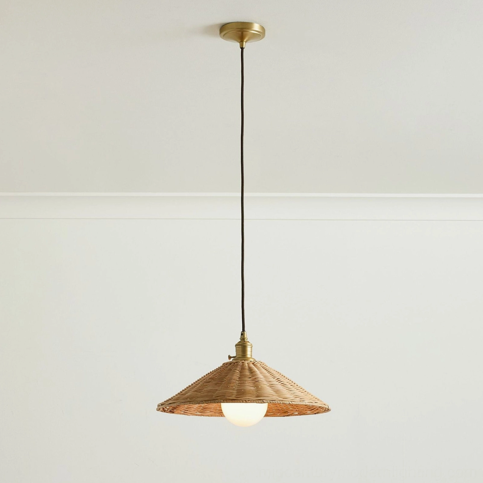Agoura compact handwoven rattan pendant shade with brass hardware, studio flat lay view