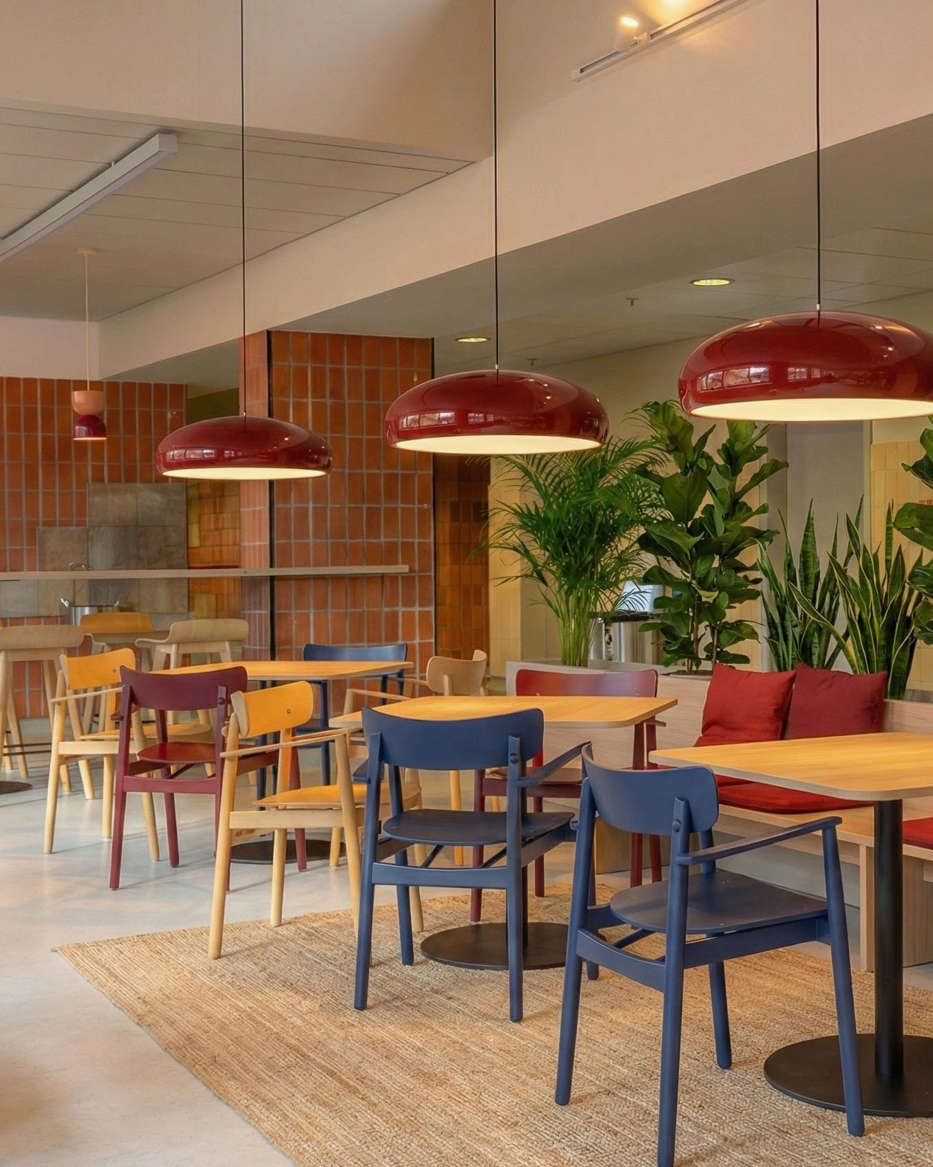 Multiple matching black dome pendant lights commercial cafe dining space mid-century design
