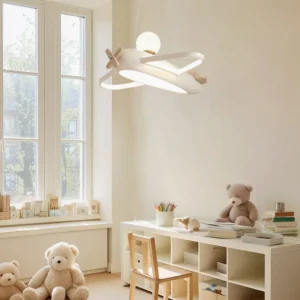 Aircraft pendant lamp installed in kids study room near window with nautical decor