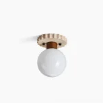 Aisle travertine ceiling lamp with frosted glass globe, side profile view showcasing organic stone texture and minimalist spherical design
