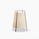 Akane Oriental-inspired table lamp with black metal frame and light brown fabric shade on white background, front studio view