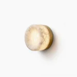 Concave disc alabaster wall sconce with brushed brass base on white background, flat frontal view showcasing stone translucency