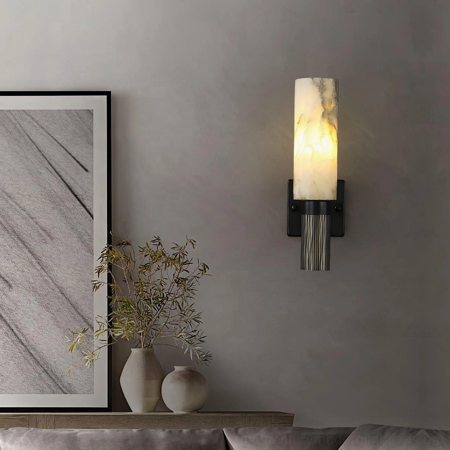 Installed alabaster cylinder sconce in contemporary home showing integration with minimalist interior design