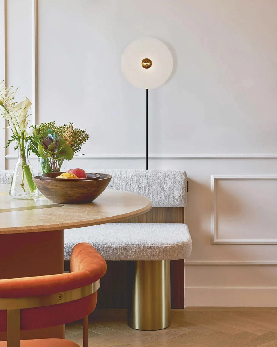 Contemporary alabaster wall light in luxury modern dining room with warm ambient glow