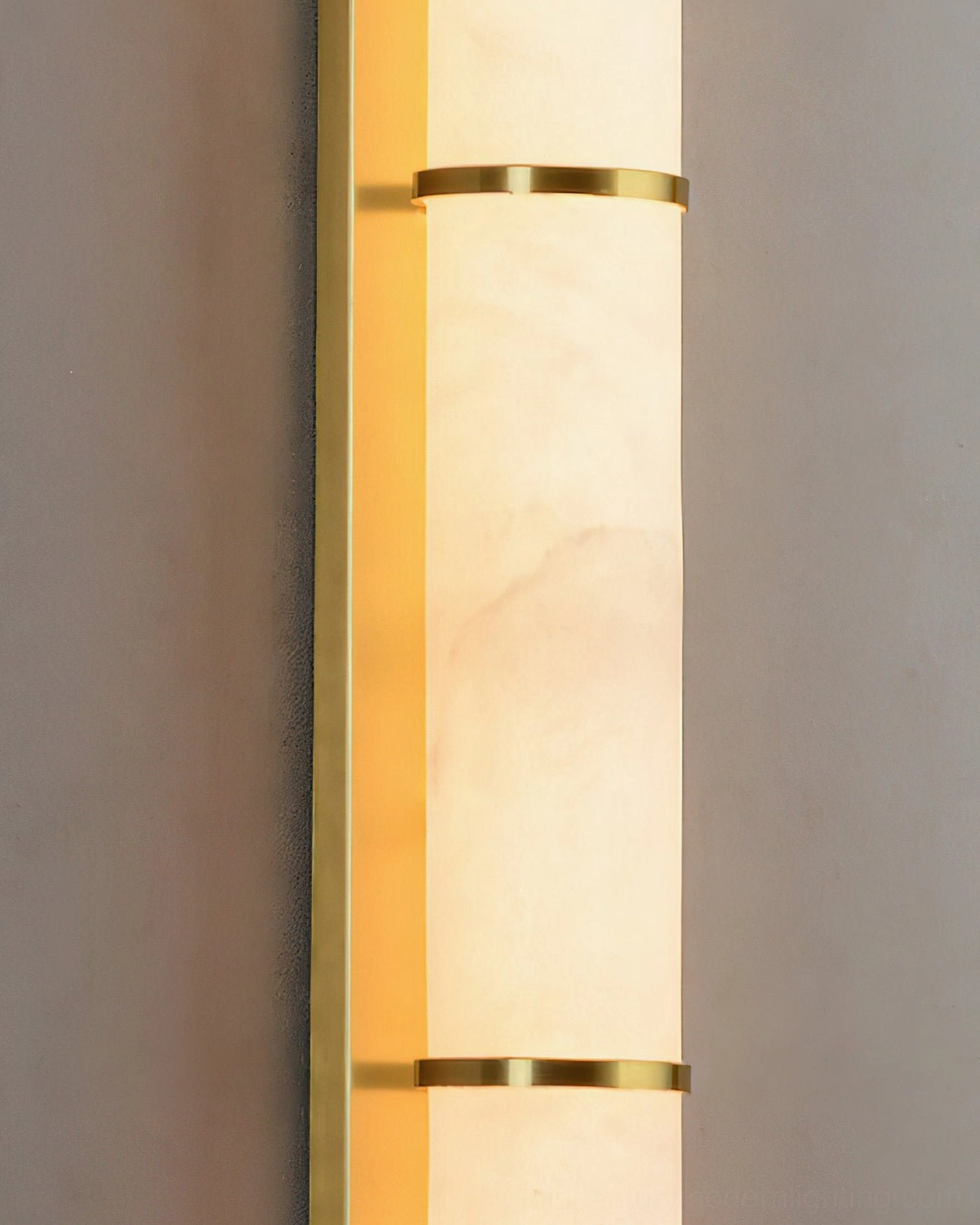 Extreme closeup of natural alabaster material with brass gold decorative bands showing veining and texture