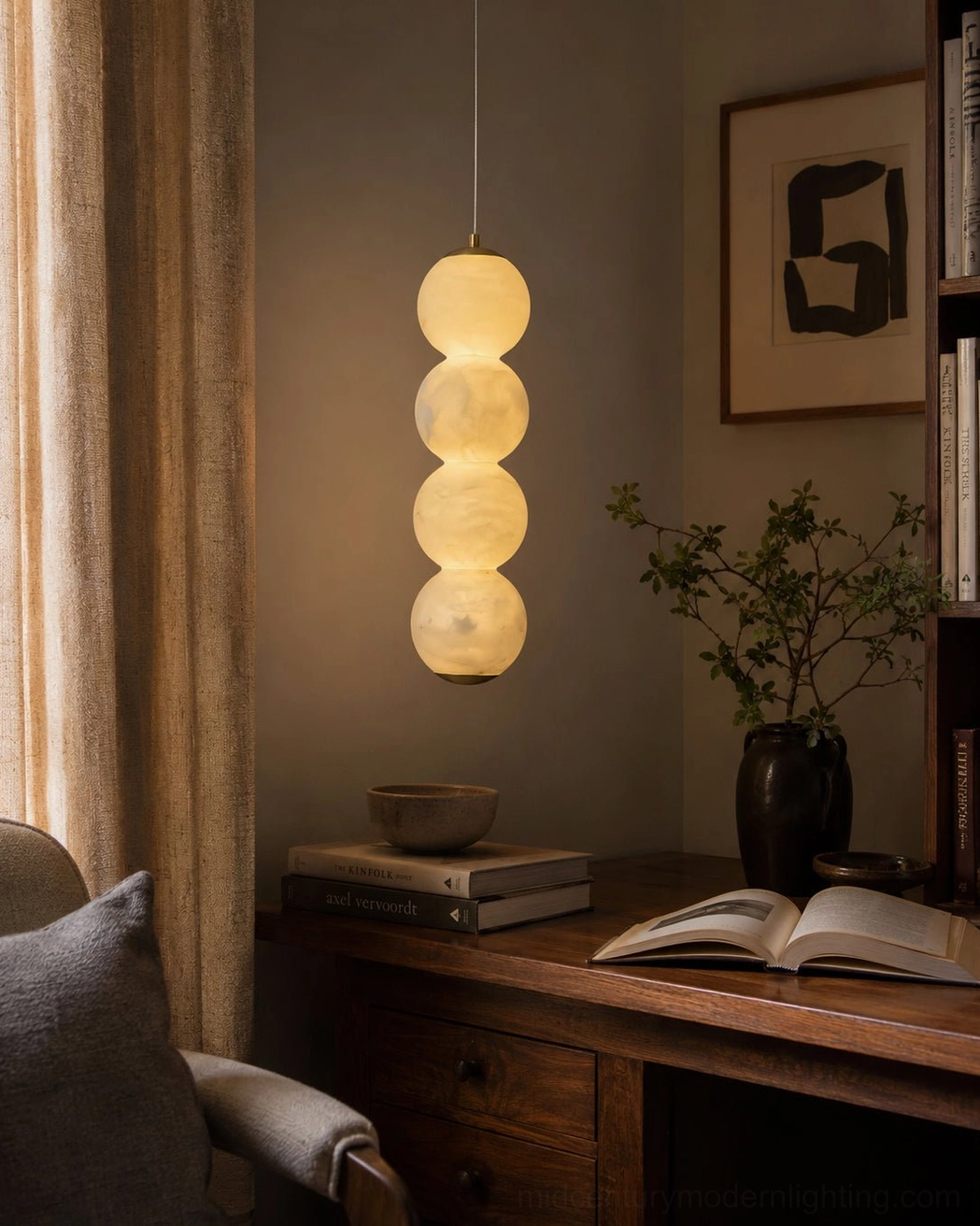 Stacked alabaster sphere pendant creating ambient glow over home office desk workspace
