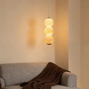 Modern stacked alabaster pendant light glowing warm light in contemporary grey living room