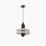 Alabaster planes pendant lamp with geometric fluted design, front studio view showing matte black hardware and translucent white alabaster stone construction