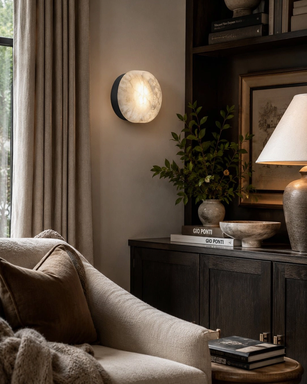 Concave disc alabaster wall sconce detailed close-up showing carved stone texture and brushed brass base construction