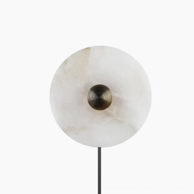 Detailed view of round alabaster wall sconce with bronze ribbed metalwork and subtle stone veining