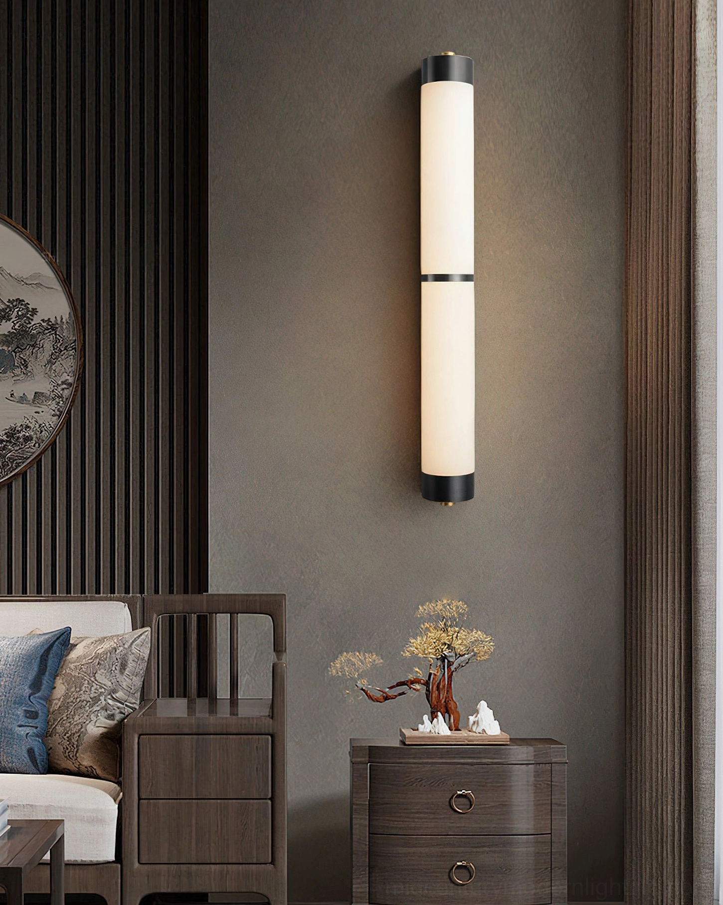Long wall-mounted cylindrical sconce in traditional Chinese interior with black and white metal trim alabaster shade
