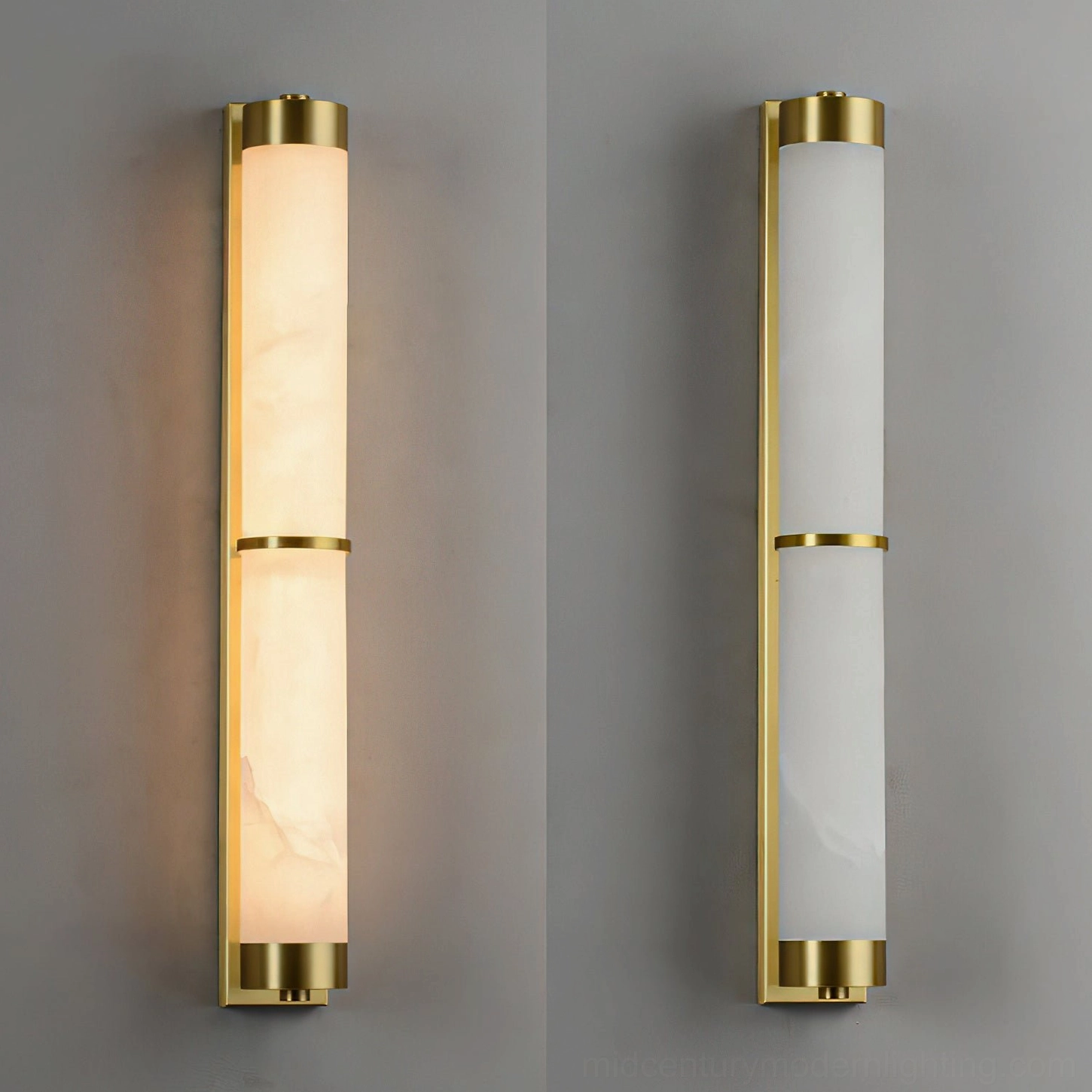Two display alabaster wall sconces side-by-side with glowing brass gold finish and split cylindrical marble shade