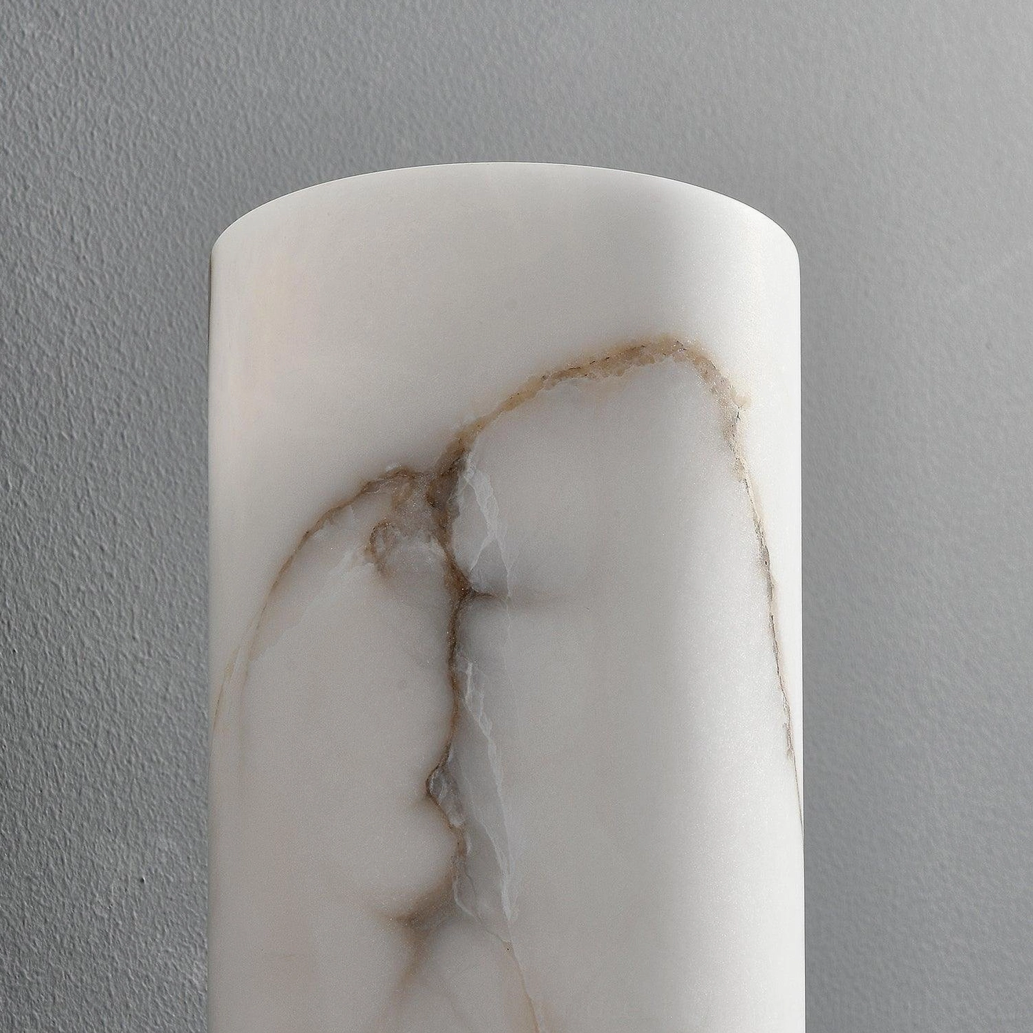 Close-up detail of alabaster lamp shade showing brown marble veining and translucent stone texture