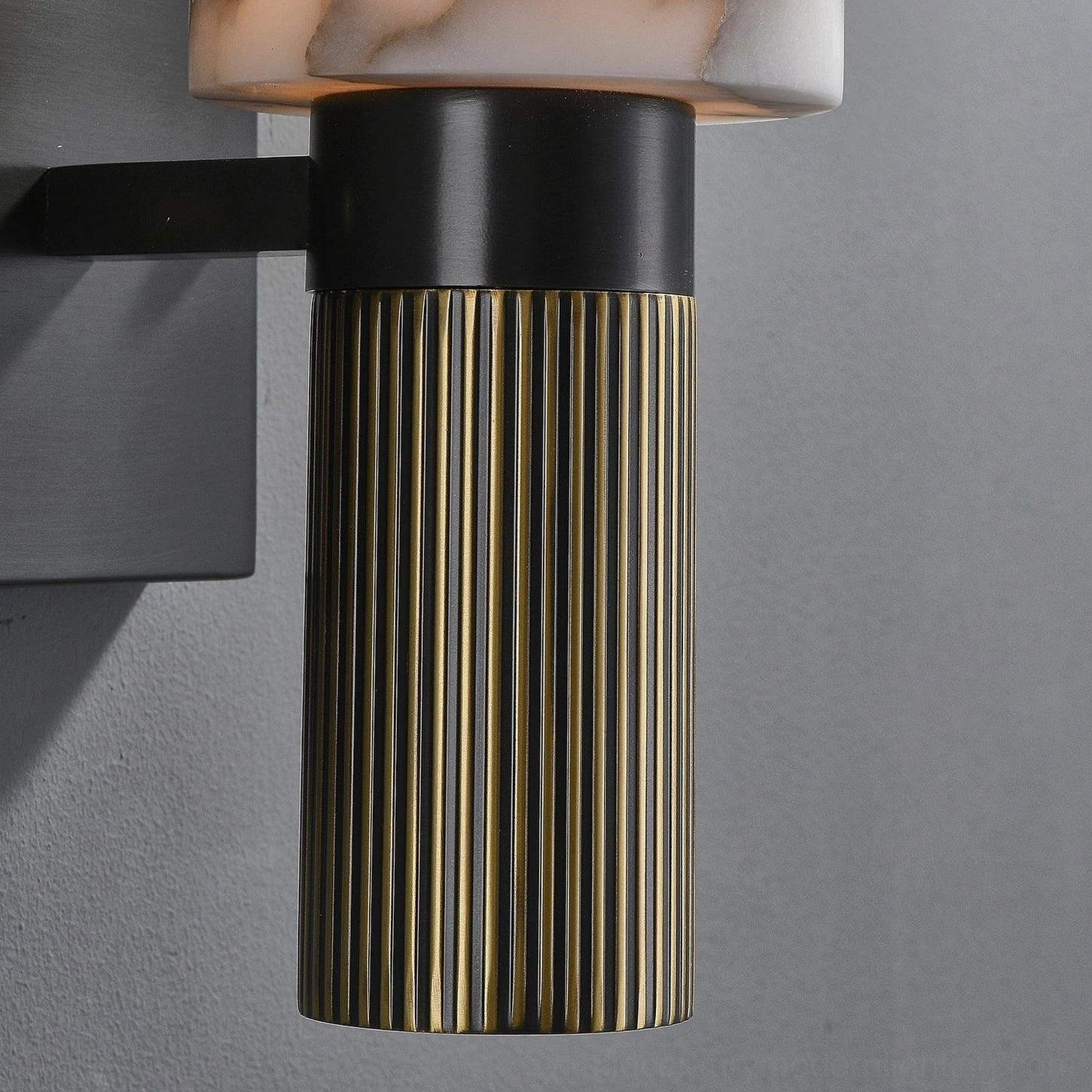 Alabaster wall lamp side profile showing depth and cylindrical proportions against neutral background