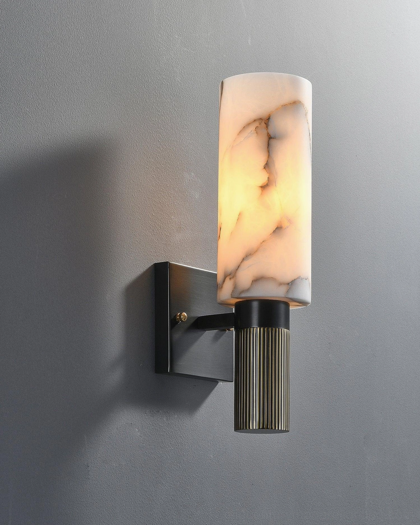 Pair of alabaster wall lamps creating gallery-style illumination in modern living room with sofa and decorative objects