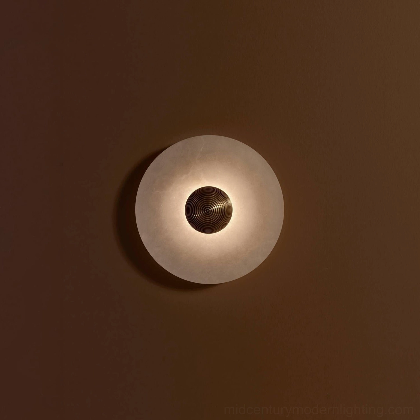 Round alabaster wall light with gold finish metal frame, warm metal accent, modern minimalist styling