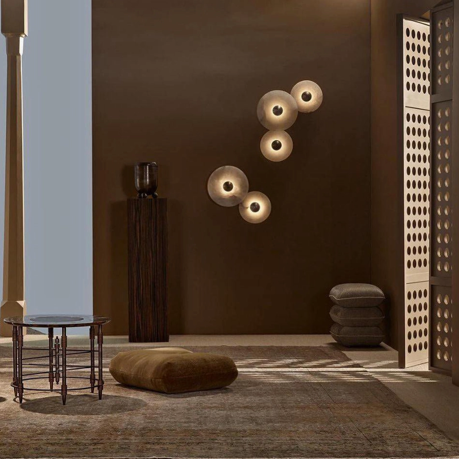 Luxury minimalist entryway with clustered round alabaster wall lamps, earth-toned interior design, ambient warm lighting