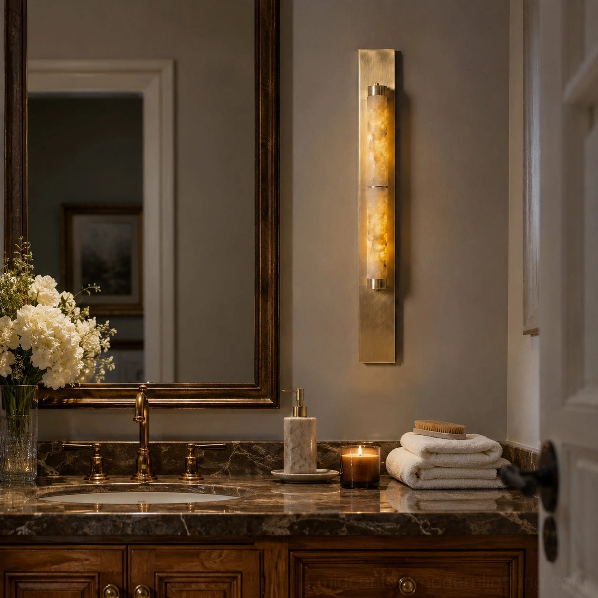 Alabaster wall lamp in luxury bathroom vanity setting with warm metal base and natural light