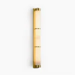 Alabaster cylindrical wall sconce with brass segmented bands, front studio view with pure white background