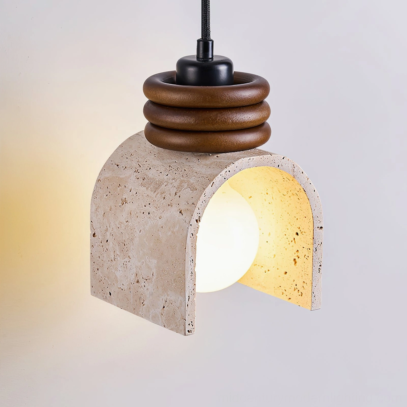 Alagusmo mid-century modern pendant light three-quarter view with warm Edison bulb illuminated and walnut wood rings