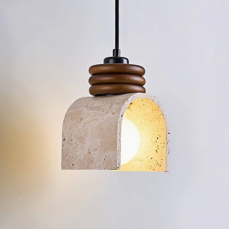 Alagusmo pendant lamp three-quarter view with warm bulb glow highlighting natural travertine arch material