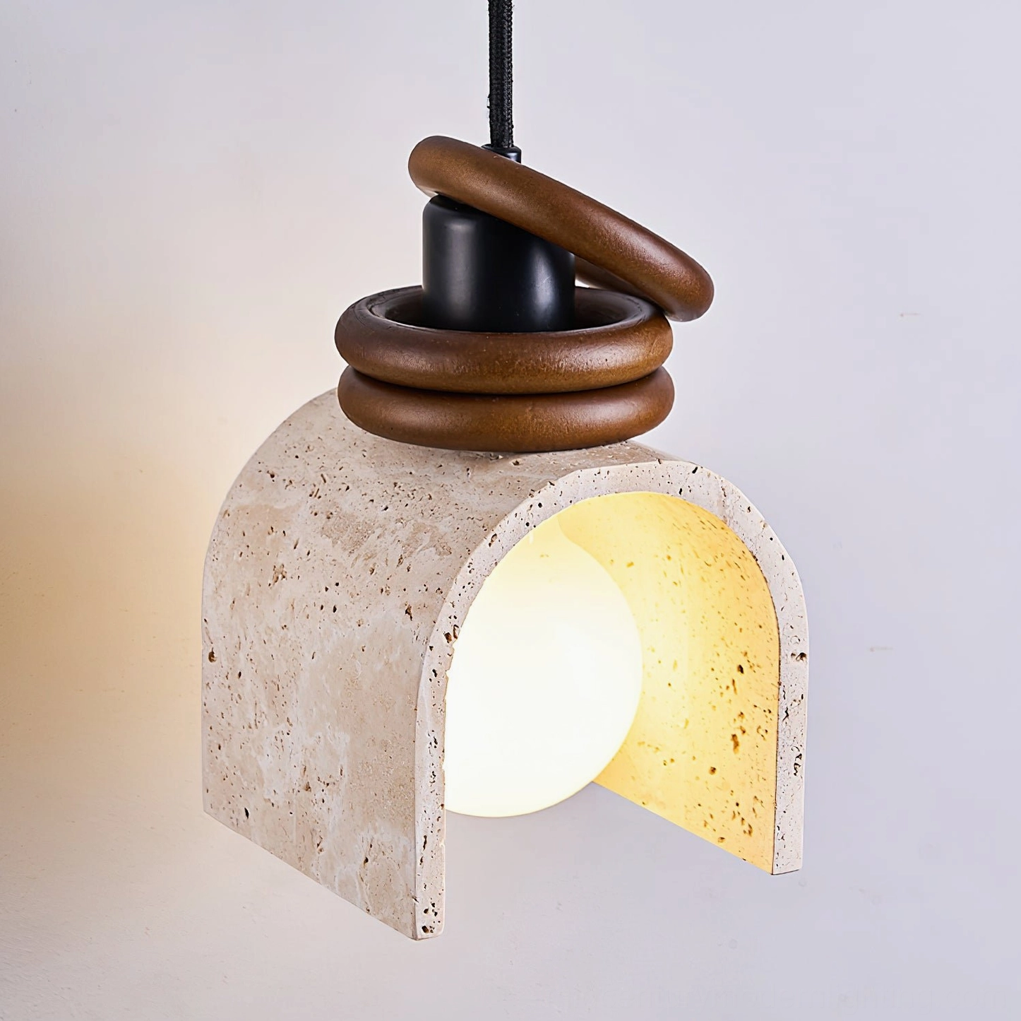 Alagusmo pendant lamp side view showing twisted walnut wooden ring accent detail with warm light