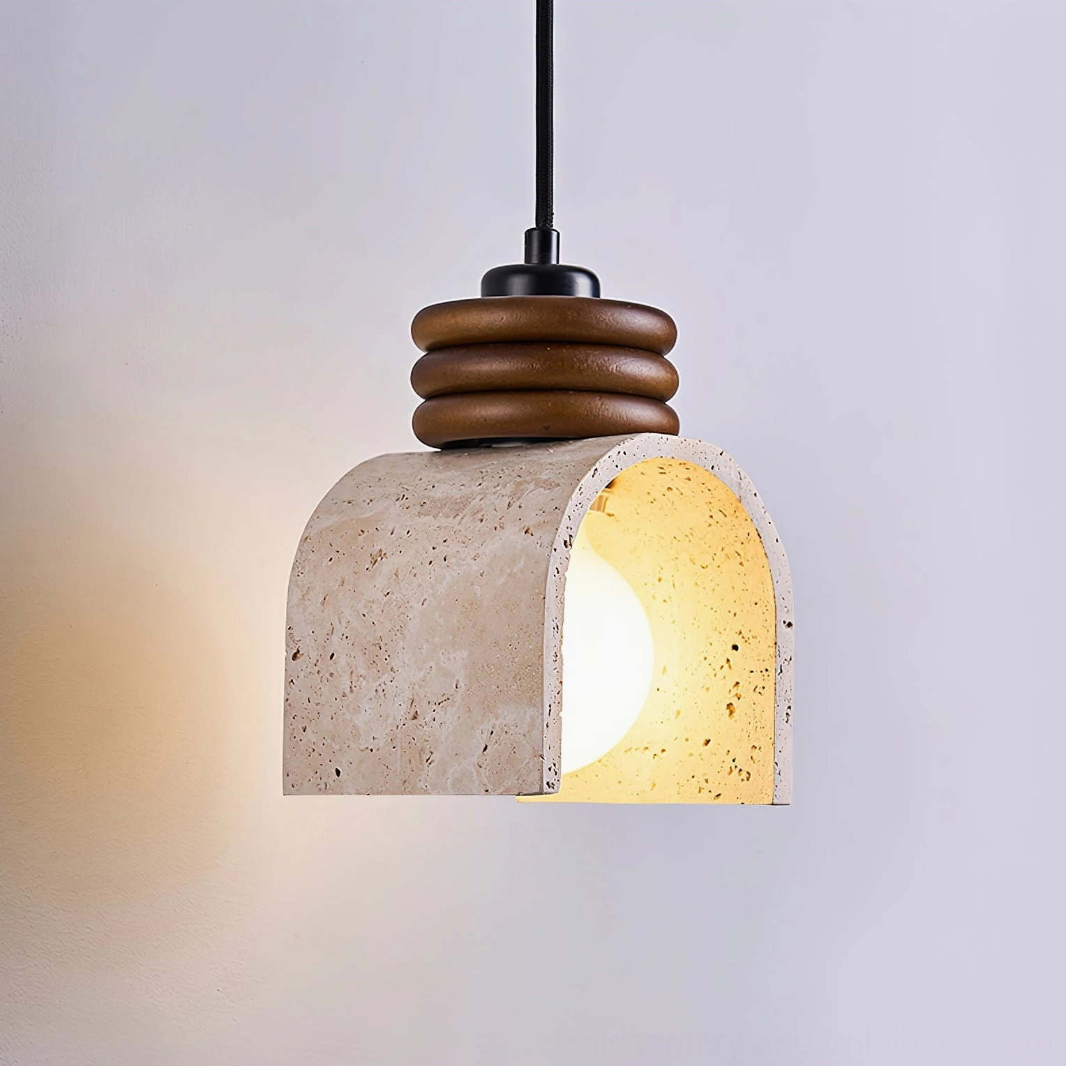 Alagusmo travertine pendant lamp three-quarter angle with warm Edison bulb and architectural design