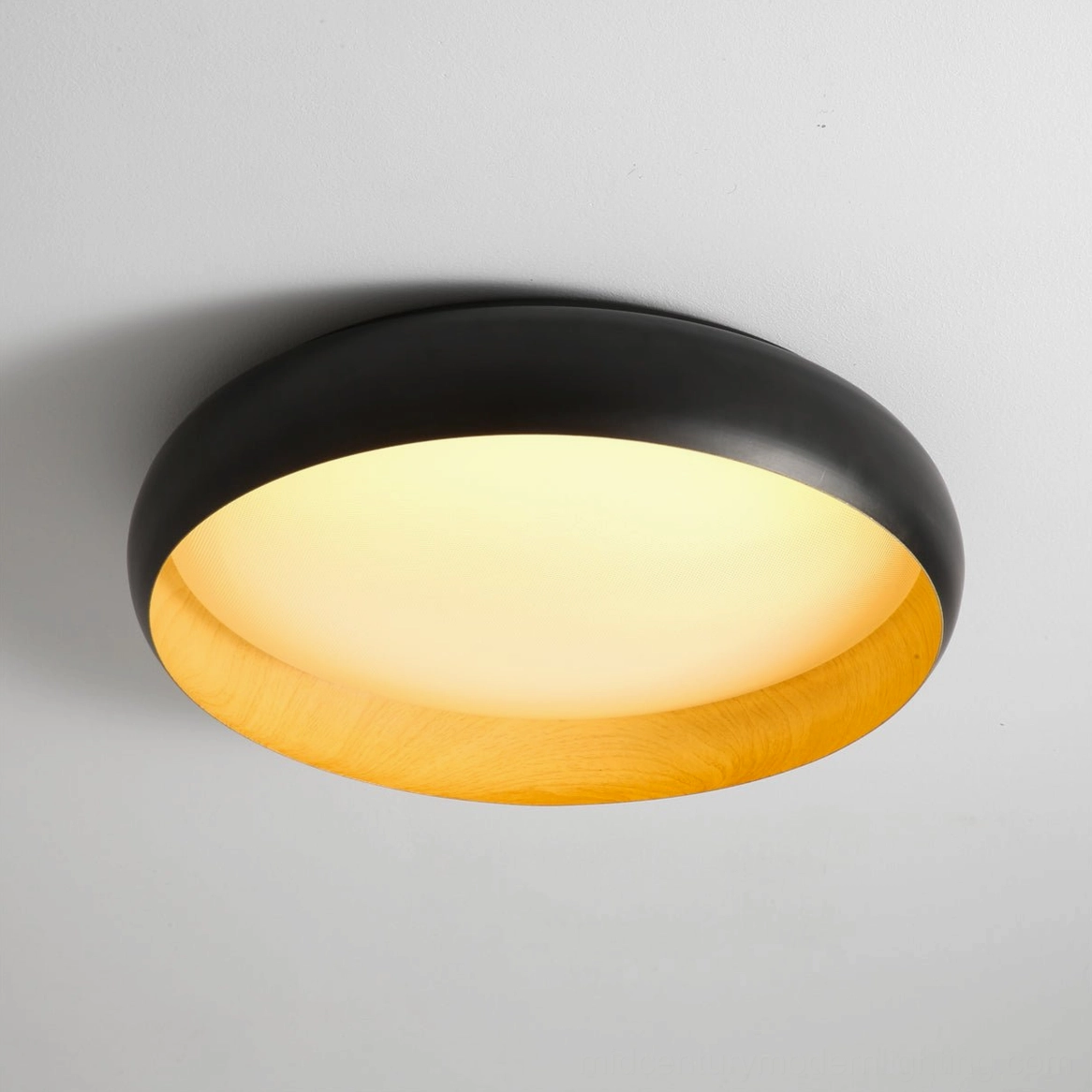 Alamus black flush ceiling lamp with warm glowing panel and wood trim detail front closeup