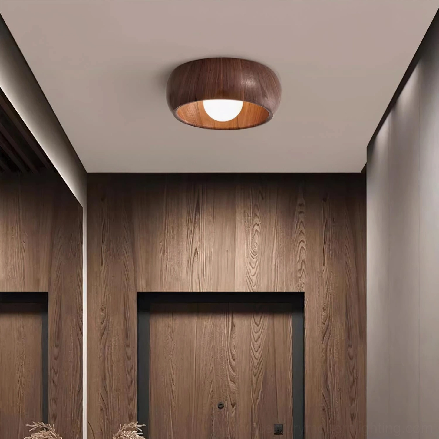 Dark wood grain Alana flush mount ceiling light in warm entryway with wood panel walls